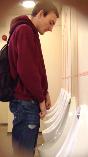 Young guy at urinal