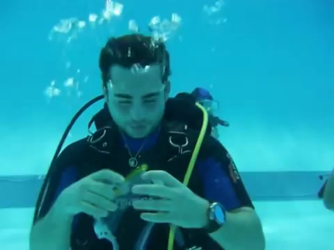 Man clearing his mask underwater