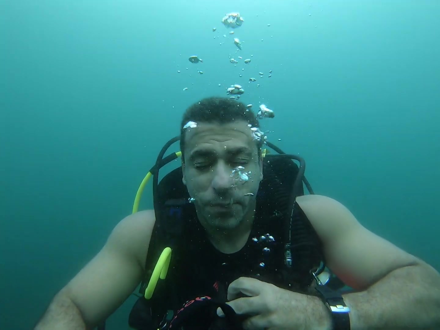 Man taking off mask underwater
