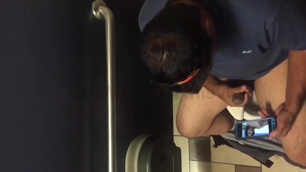 Worker stroking brown cock while on the clock