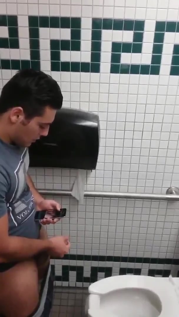 Thick uncut latin dude strokes to porn in restroom