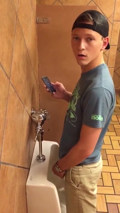 Cute boy caught at the urinal