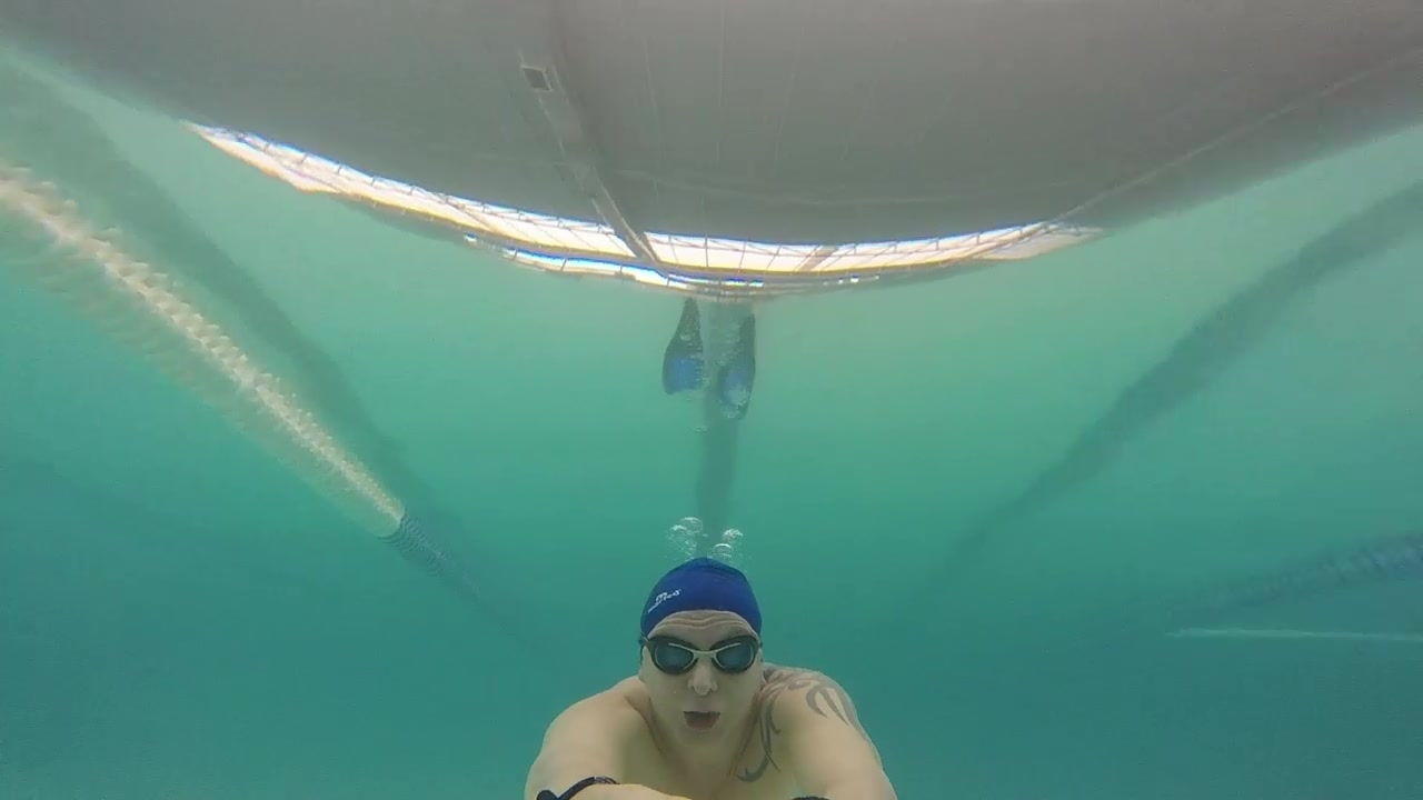 swimming underwater in a public pool