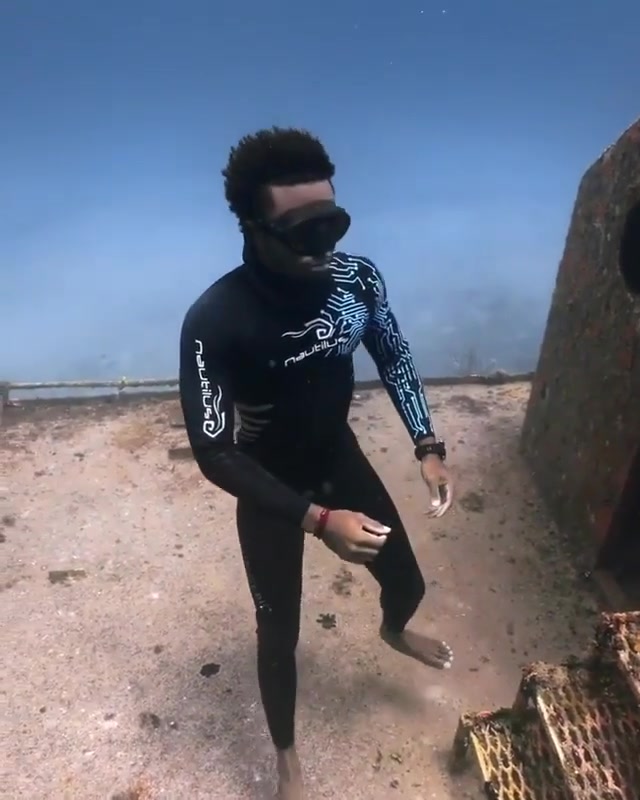 Black freediver breatholding underwater