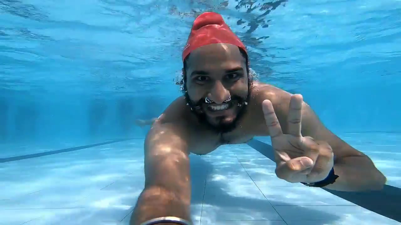 Arab buddies barefaced underwater in pool