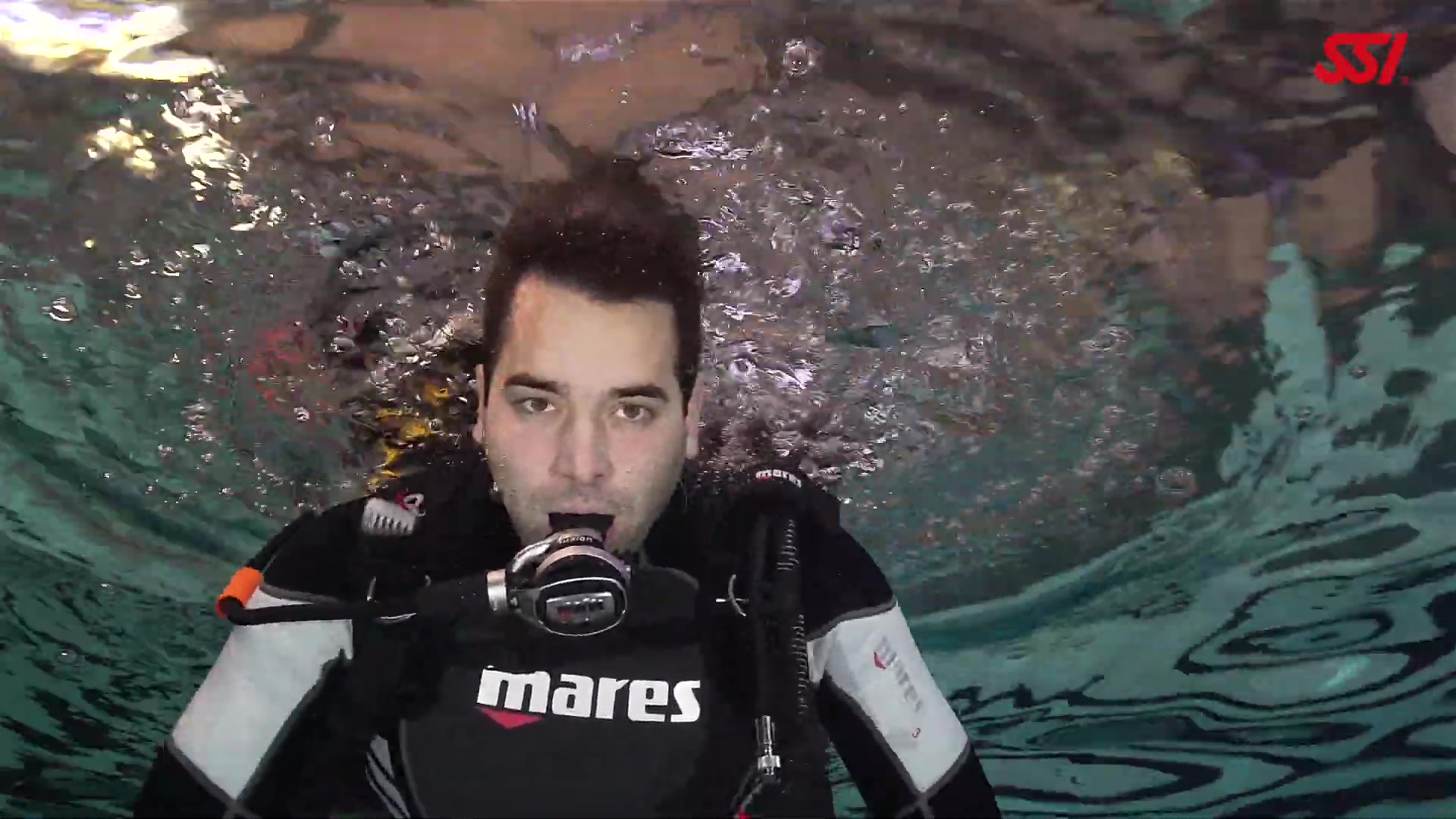 Hot scubadiver breathing barefaced underwater