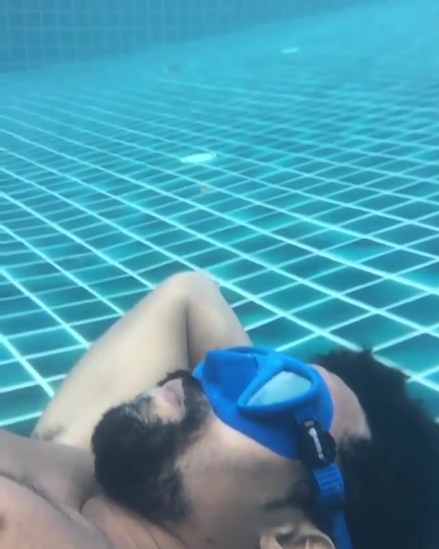 Blowing bubbles underwater in pool