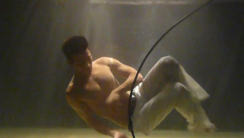 Barefaced man performs underwater