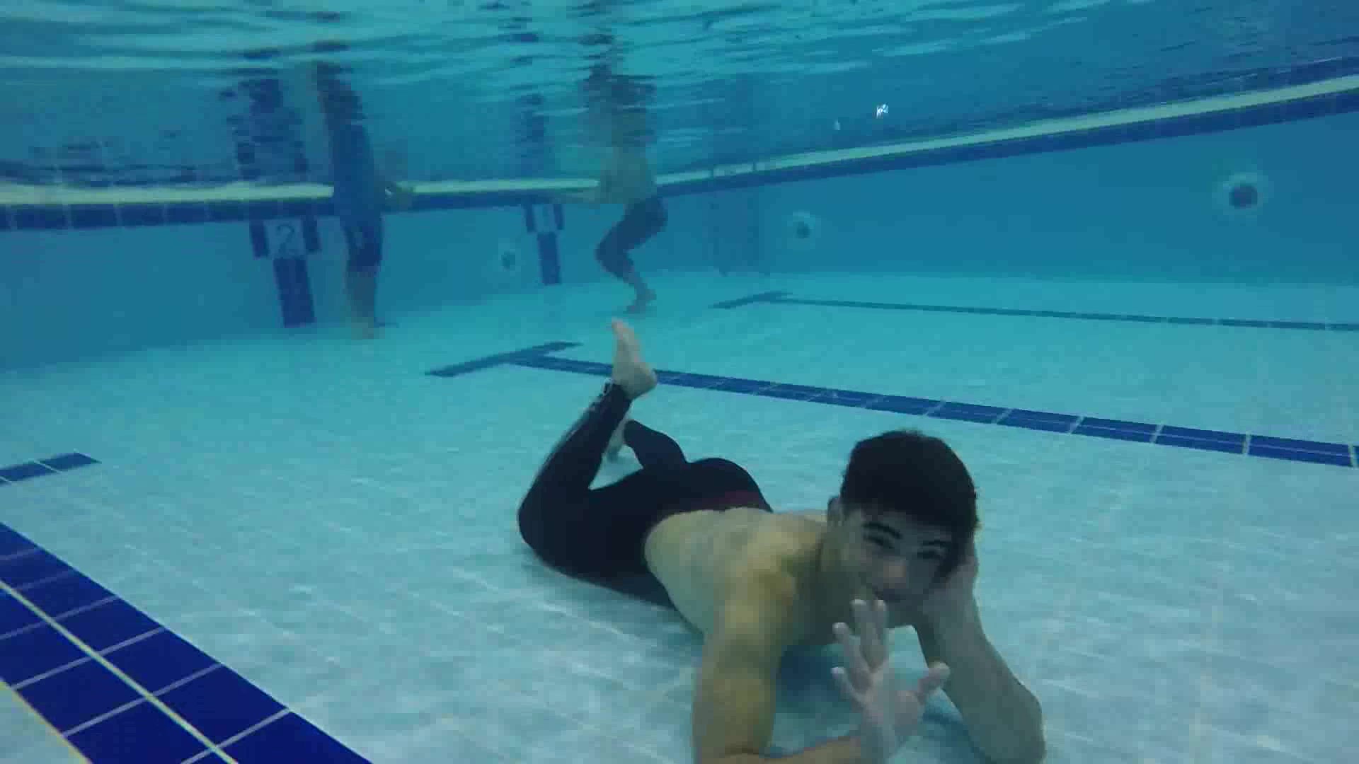 Barefaced arabs exercising underwater in pool