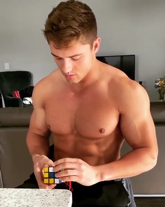 man with hard nipples solves a rubiks cube