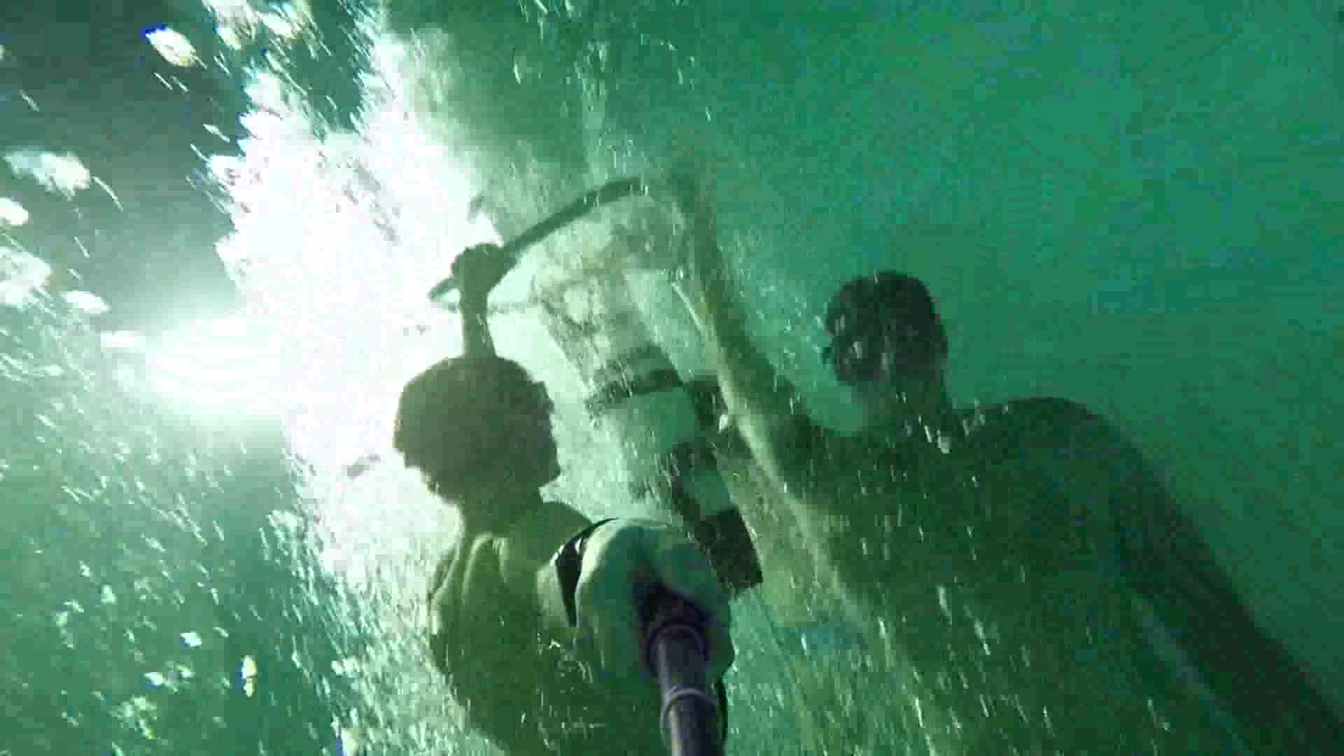 Freedivers breatholding deep underwater in speedos