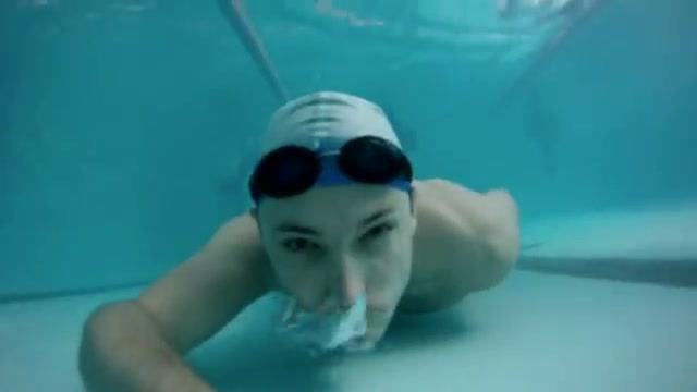 Swimmer in speedo barefaced underwater