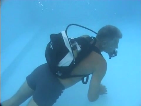 Mature scubadiver barefaced underwater