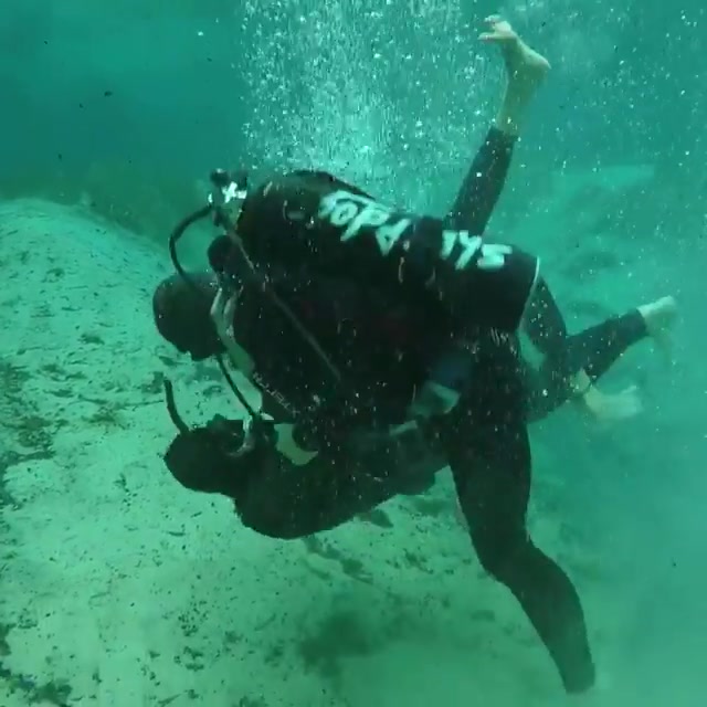 Scubadivers fighting hard underwater