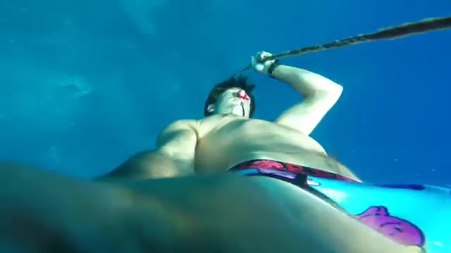 Freediving barefaced underwater in bulging speedos