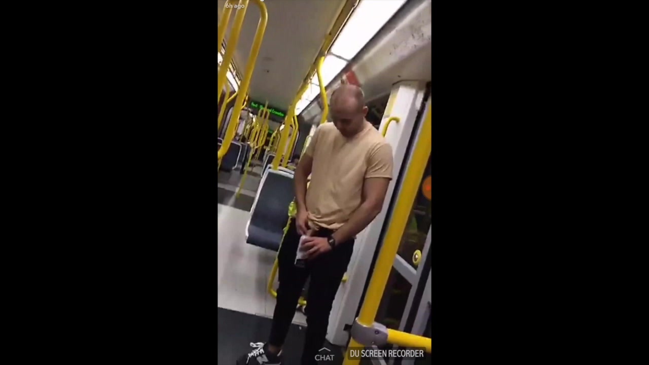 Drunk lad pissing in a can on the tram
