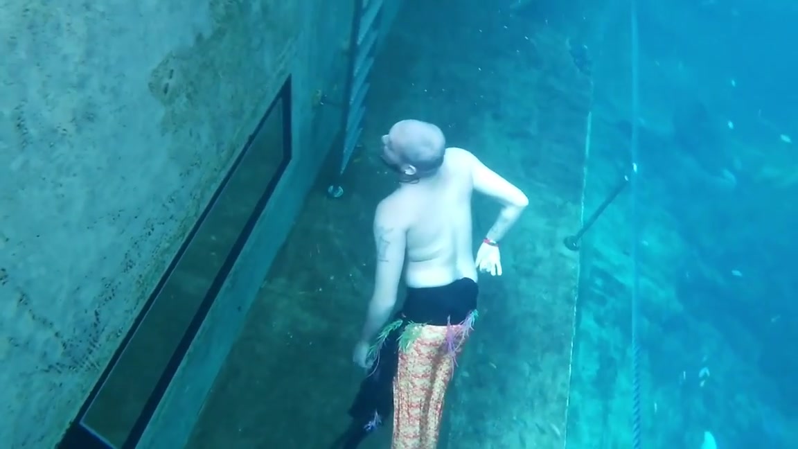 Merman breatholding barefaced underwater