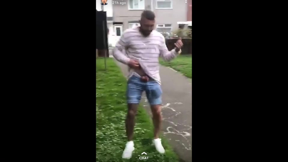 Lad pissing in the park after leaving the pub