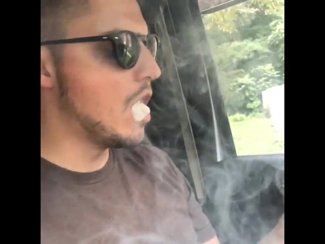 sexy guy in car smoking a cigar