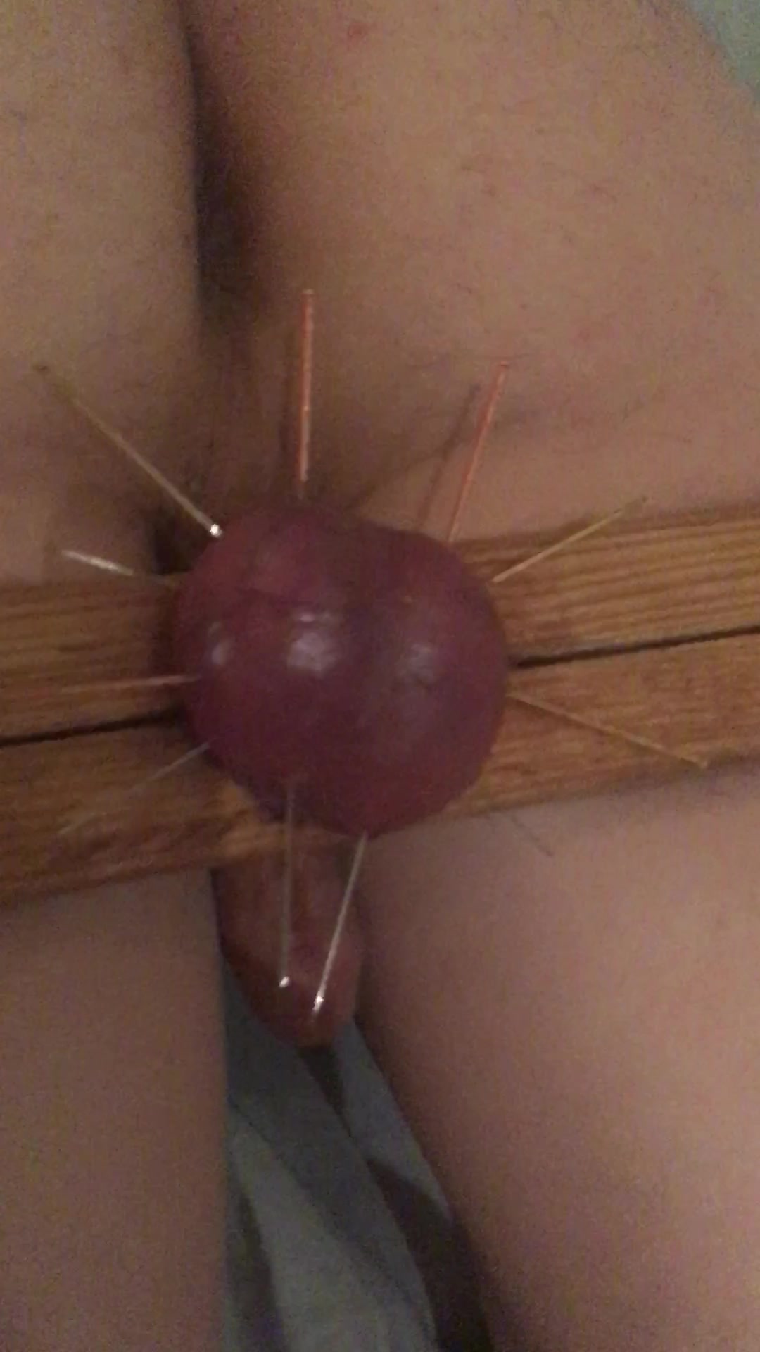 Young teen with needles perforing his testicles
