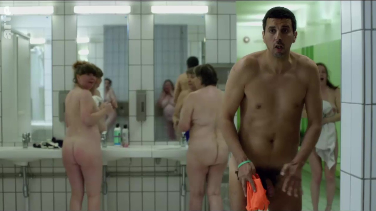 A naked guy wanders into the wrong locker room after his shower. 