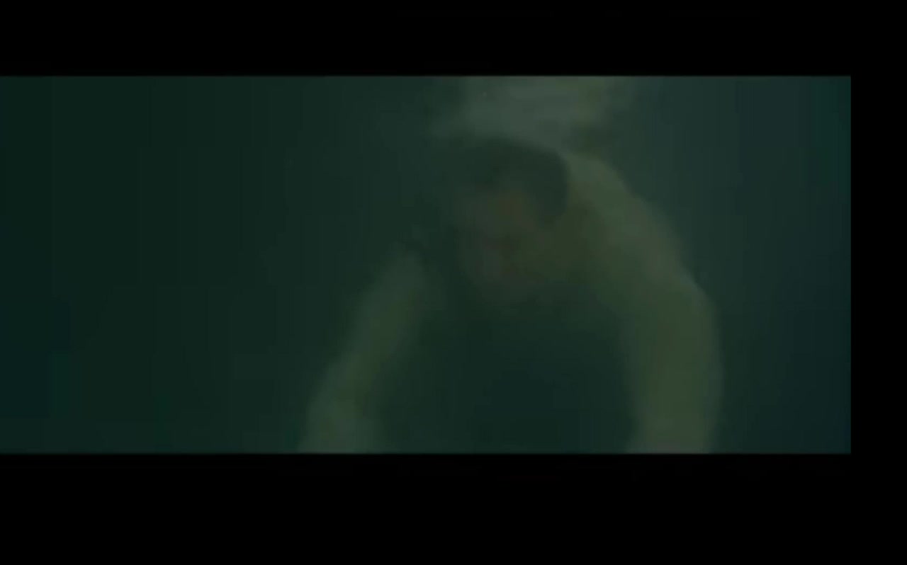 Clothed and barefaced underwater in sea