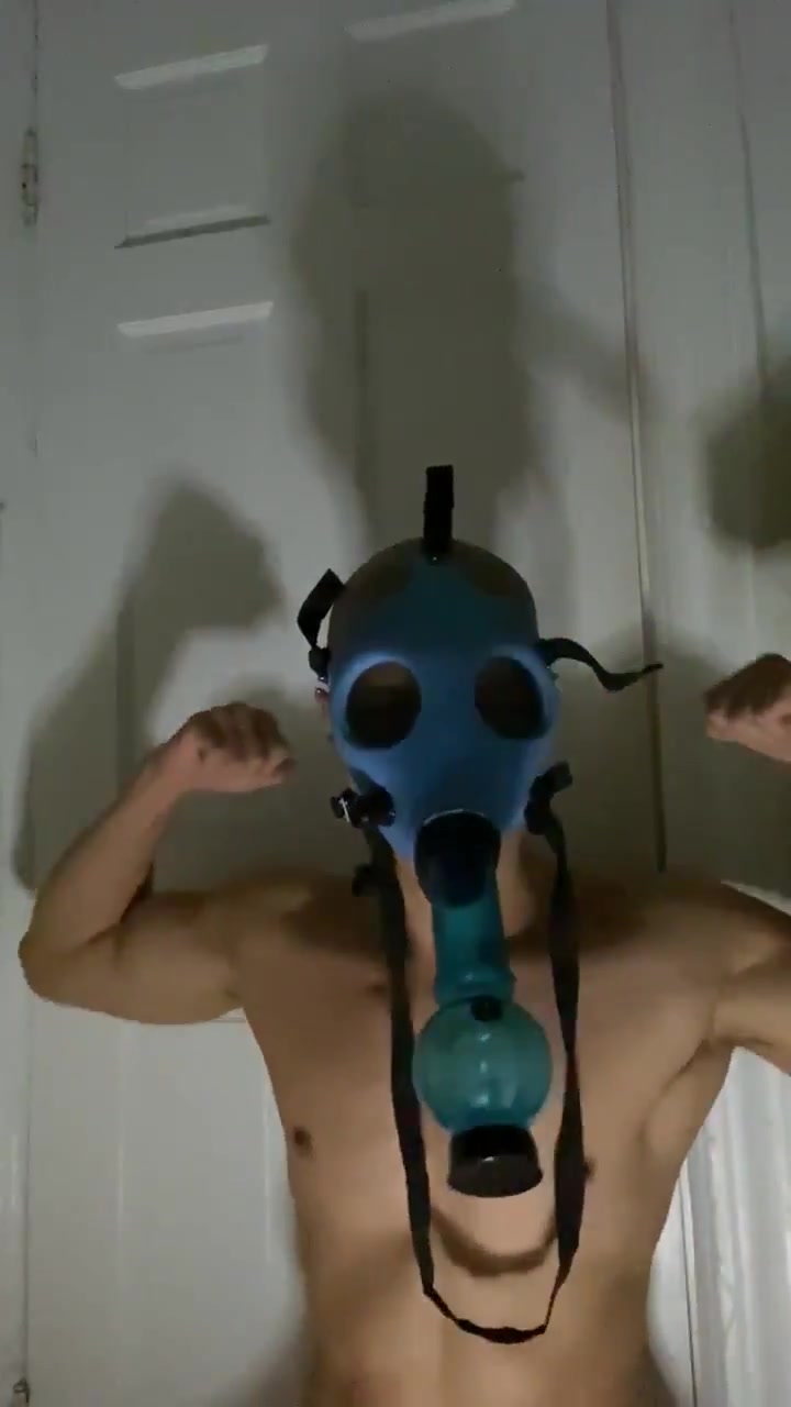 Asian guy uses gas mask to be poppered up