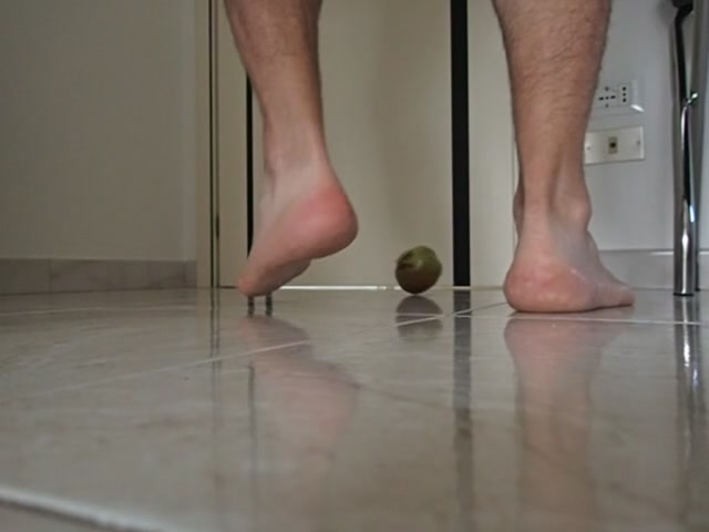 barefoot playing with a pomegranate