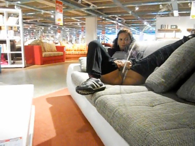Lady pees on the sofa in the furniture shop