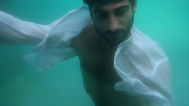 Underwater barefaced clothed male model