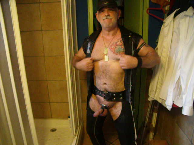 Daddy in leather, playing with his nips and cock