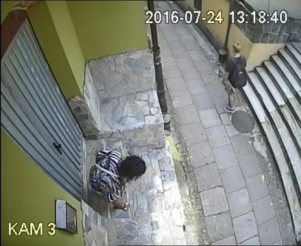 Woman pees on stairs in front of entrance