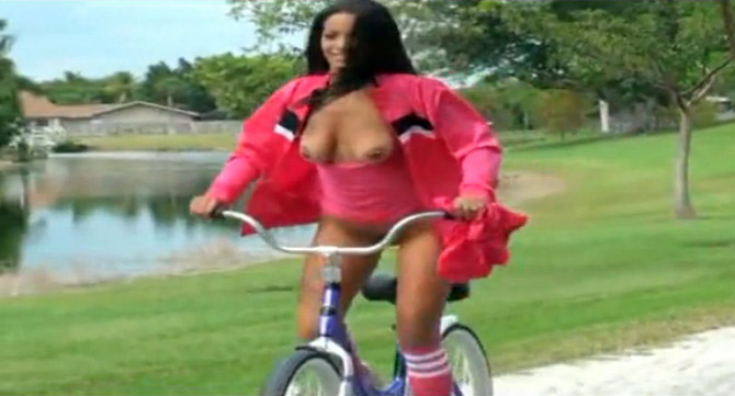 Nude bicycle riding in her neighborhood