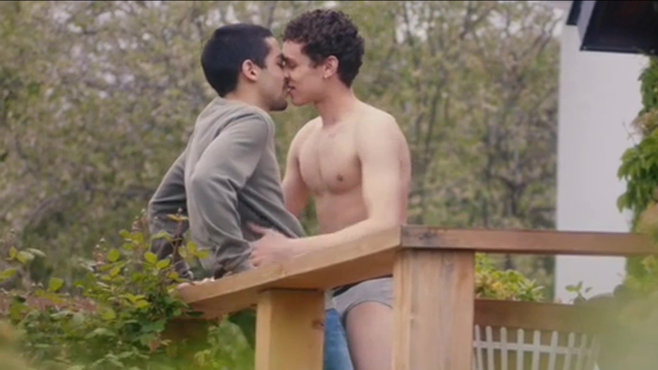 Spanish summer lovers kissing at garden