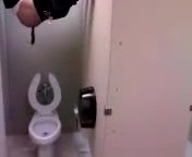 Dude shitting into toilet from the top of the stall