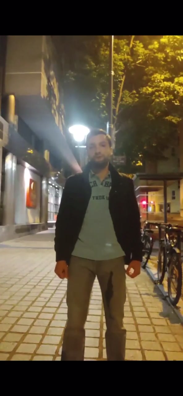 Hot bearded guy pissing his pants on the street