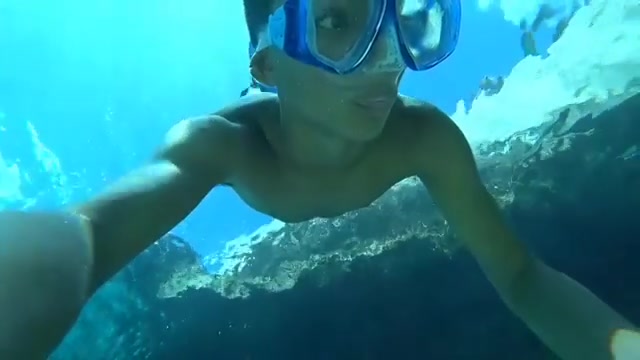 Barechested freediver breatholding underwater