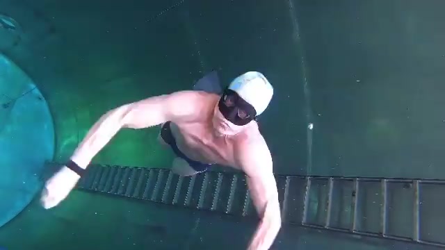 Freediving underwater in bulging speedos