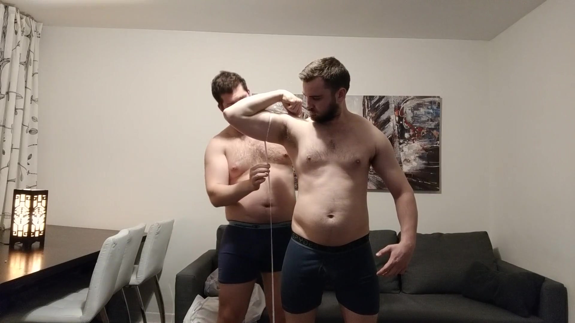 two chunky guys measure each other