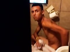 Young guy naked on toilet