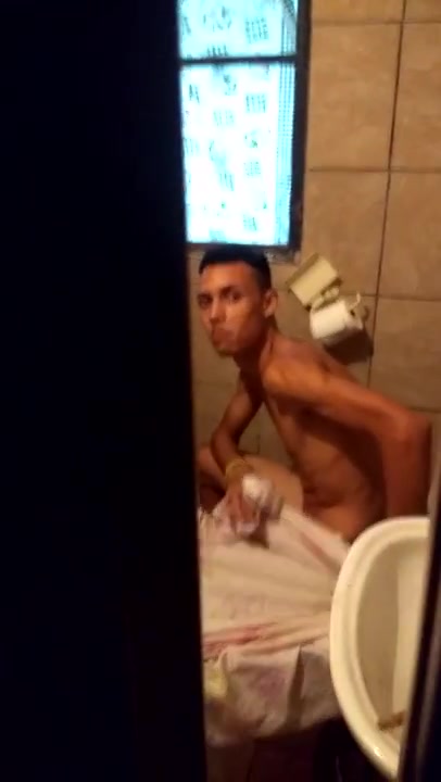 Young guy naked on toilet