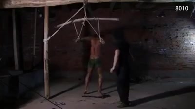 Shirtless Asian man tied up and whipped in prison