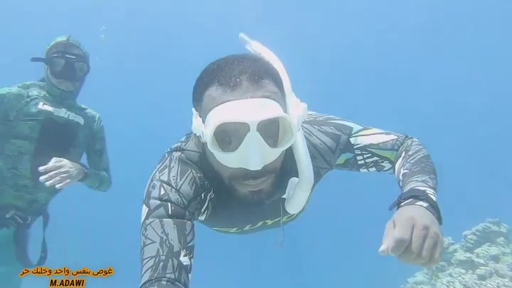 Arab cute freediver breatholds underwater with friend