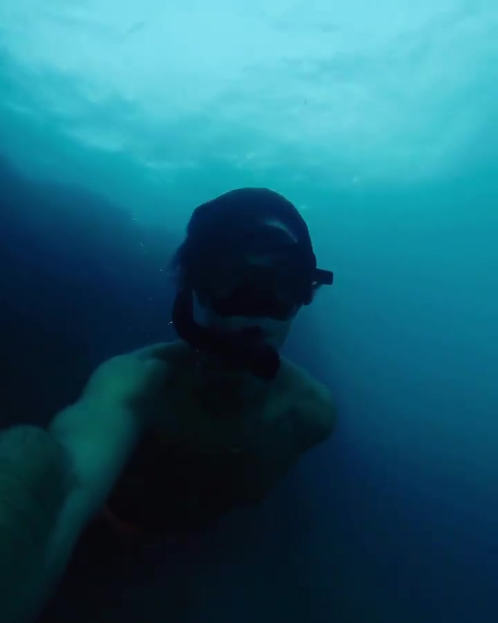 Skinny guy freediving underwater