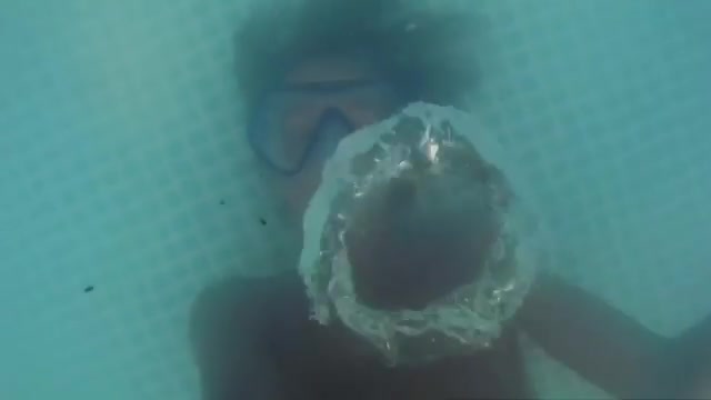Blowing bubbles underwater with mask