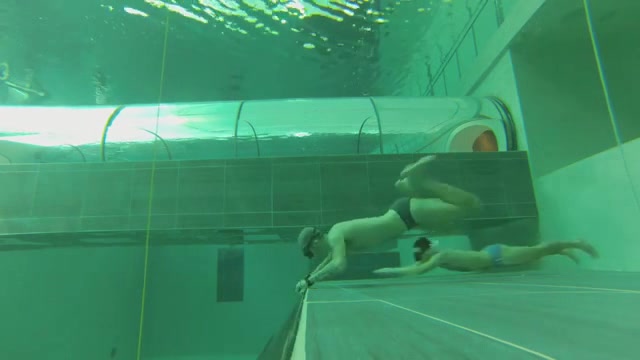 Freedivers in speedos breatholding underwater