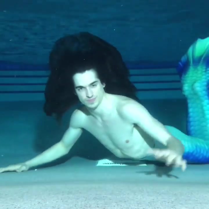 Long haired merman breatholding barefaced underwater