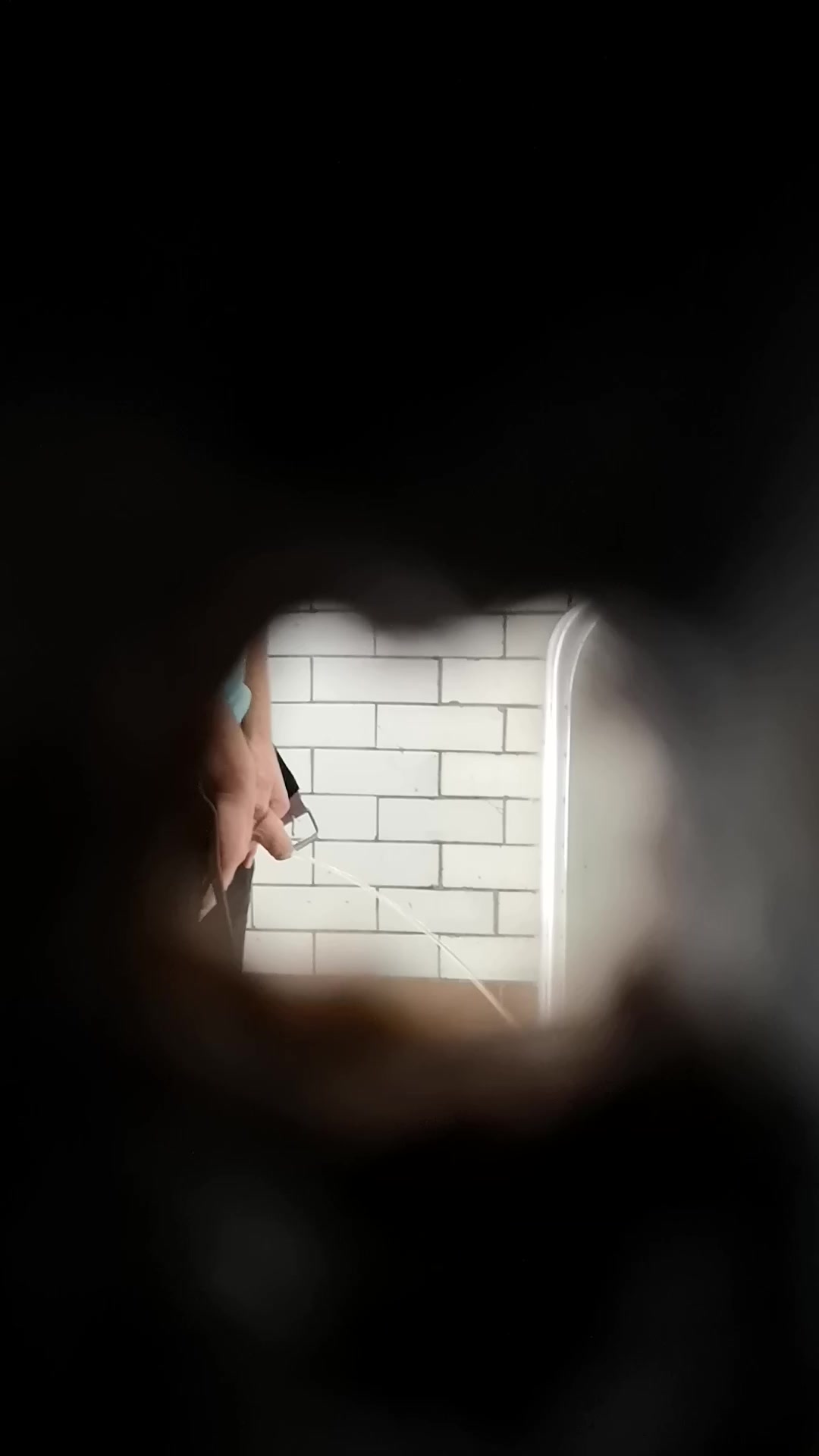 Public urinal spy hole