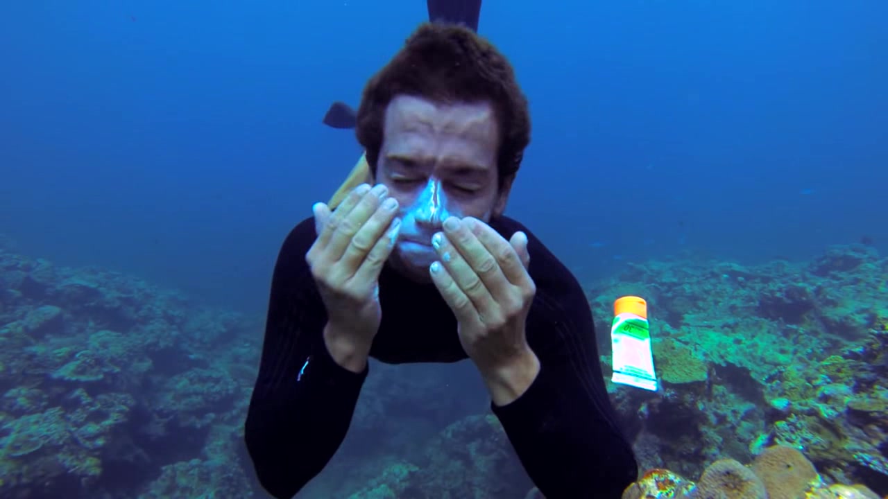 Barefaced freediver breatholding underwater in sea
