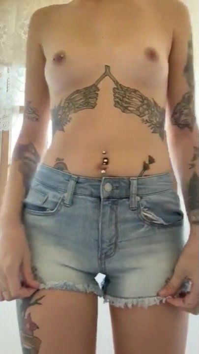 sexy topless skinny girl with tattoos urinates